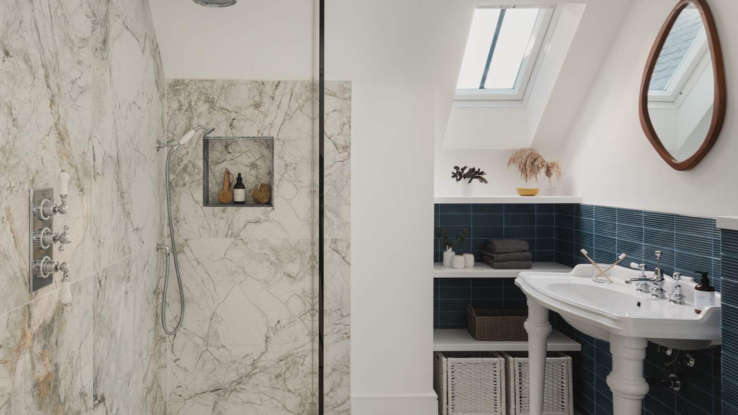 This bedroom has an ensuite with a walk-in shower and rainfall shower head