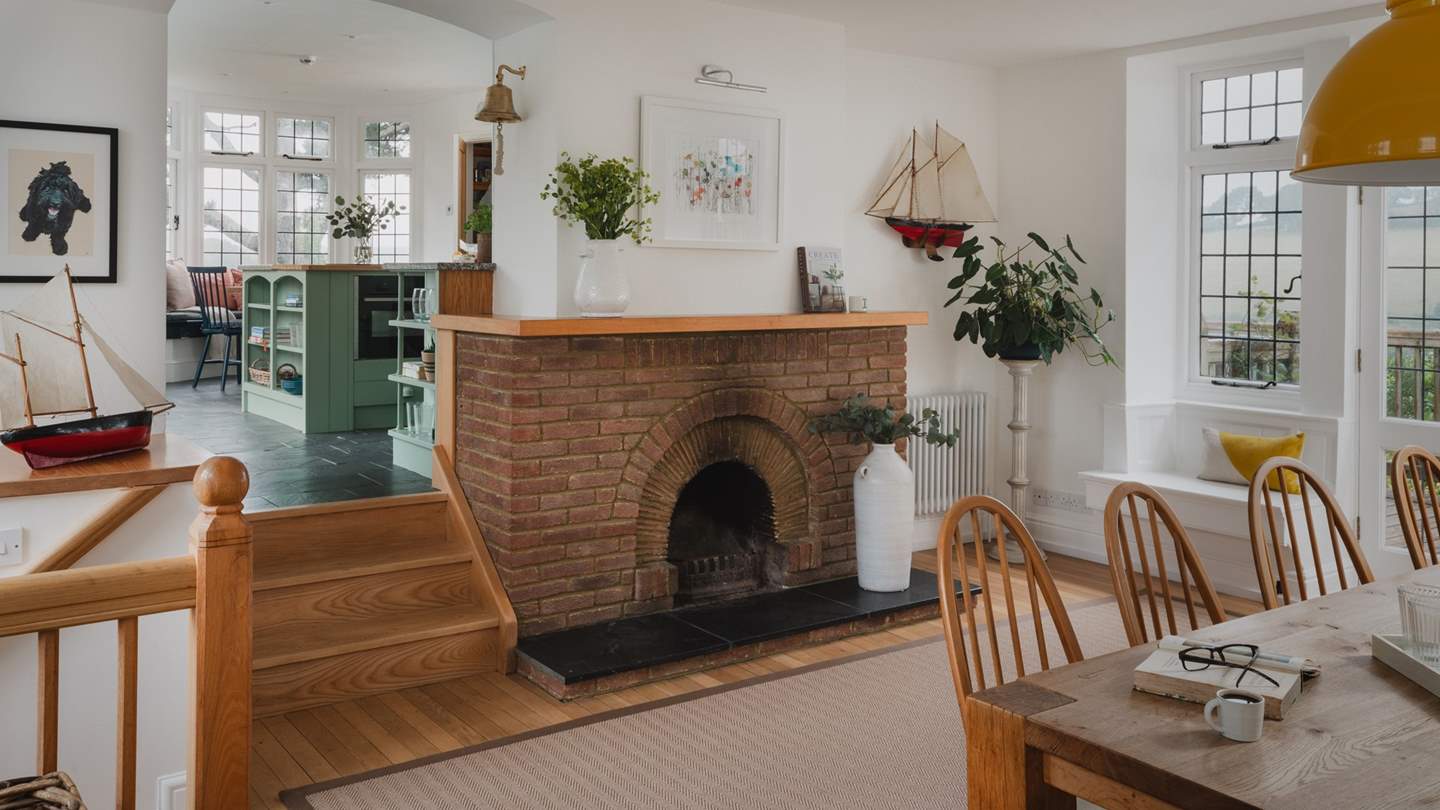 Adding ambience is an original fireplace set within an exposed brick hearth