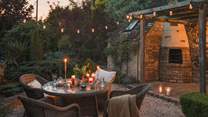 The suntrap garden beckons, garlanded by greenery and enchanting festoon lighting