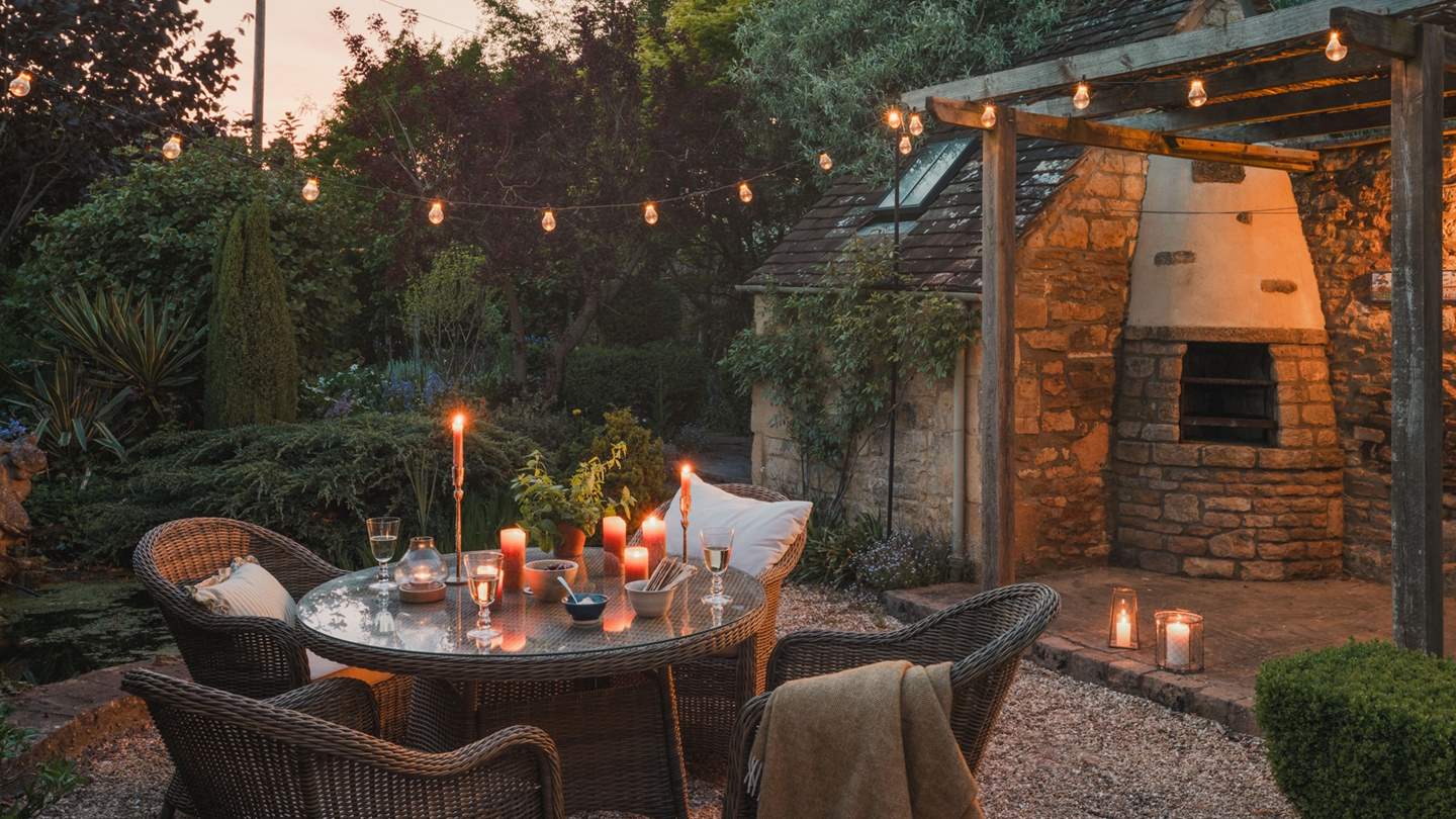 The suntrap garden beckons, garlanded by greenery and enchanting festoon lighting