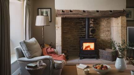 A picture of rustic romance, the welcoming living room and adjoining dining area epitomise country cottage charm