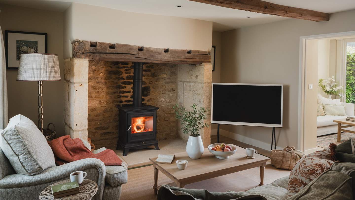 Set within an original fireplace and period mantel, a wood burning stove radiates warmth in the cooler months