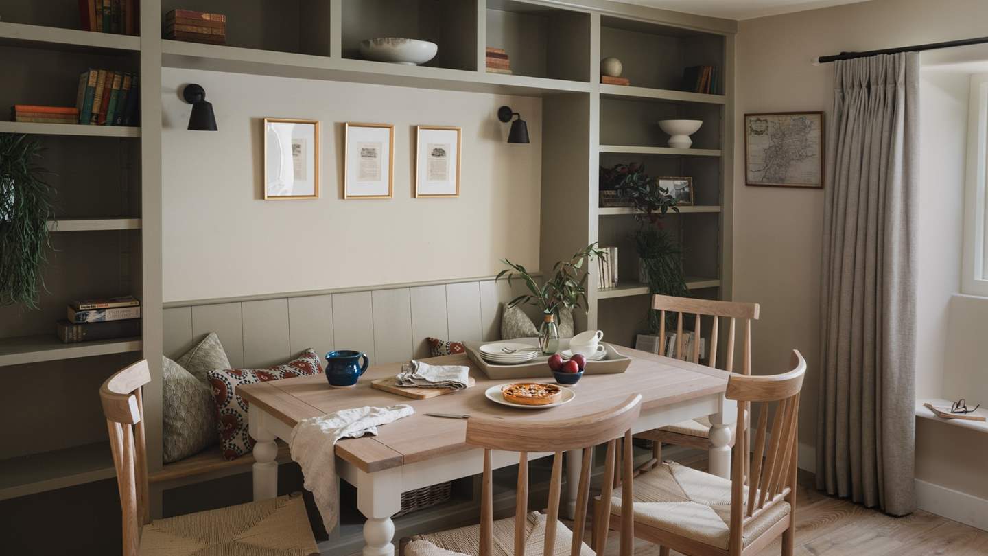 The welcoming dining area is framed by bespoke carpentry and a Neptune dining table