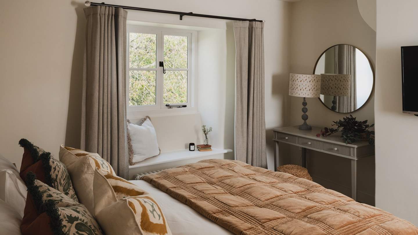 A warm palette of ivory, forest greens and cinnamon reflect the earthy tones beyond the window