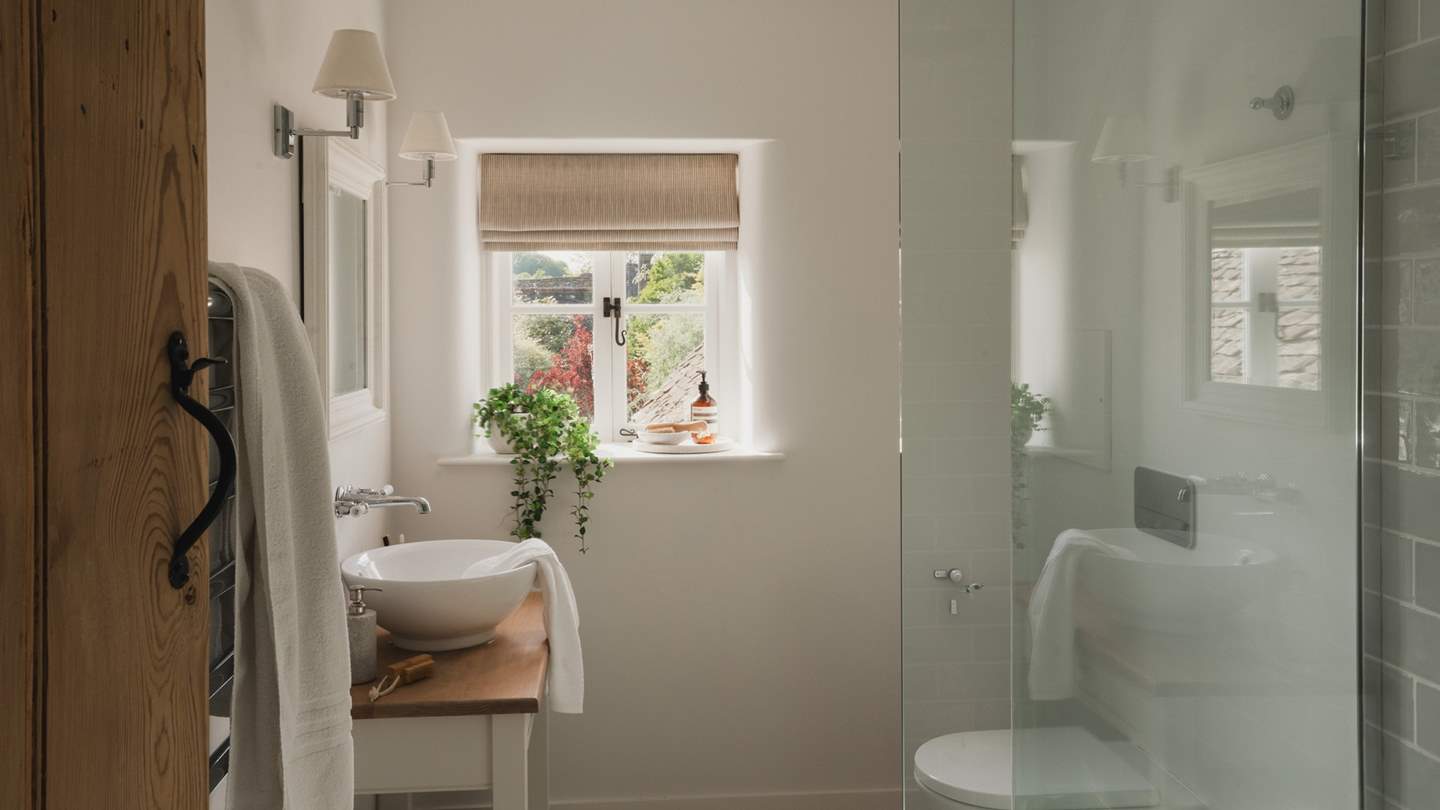 The shared family bathroom offers a walk-in Hansgrohe shower 
