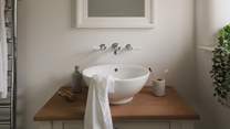 This space features a quaint Neptune washstand 