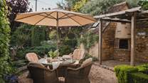 Alfresco magic resides beneath the shade of the pretty parasol