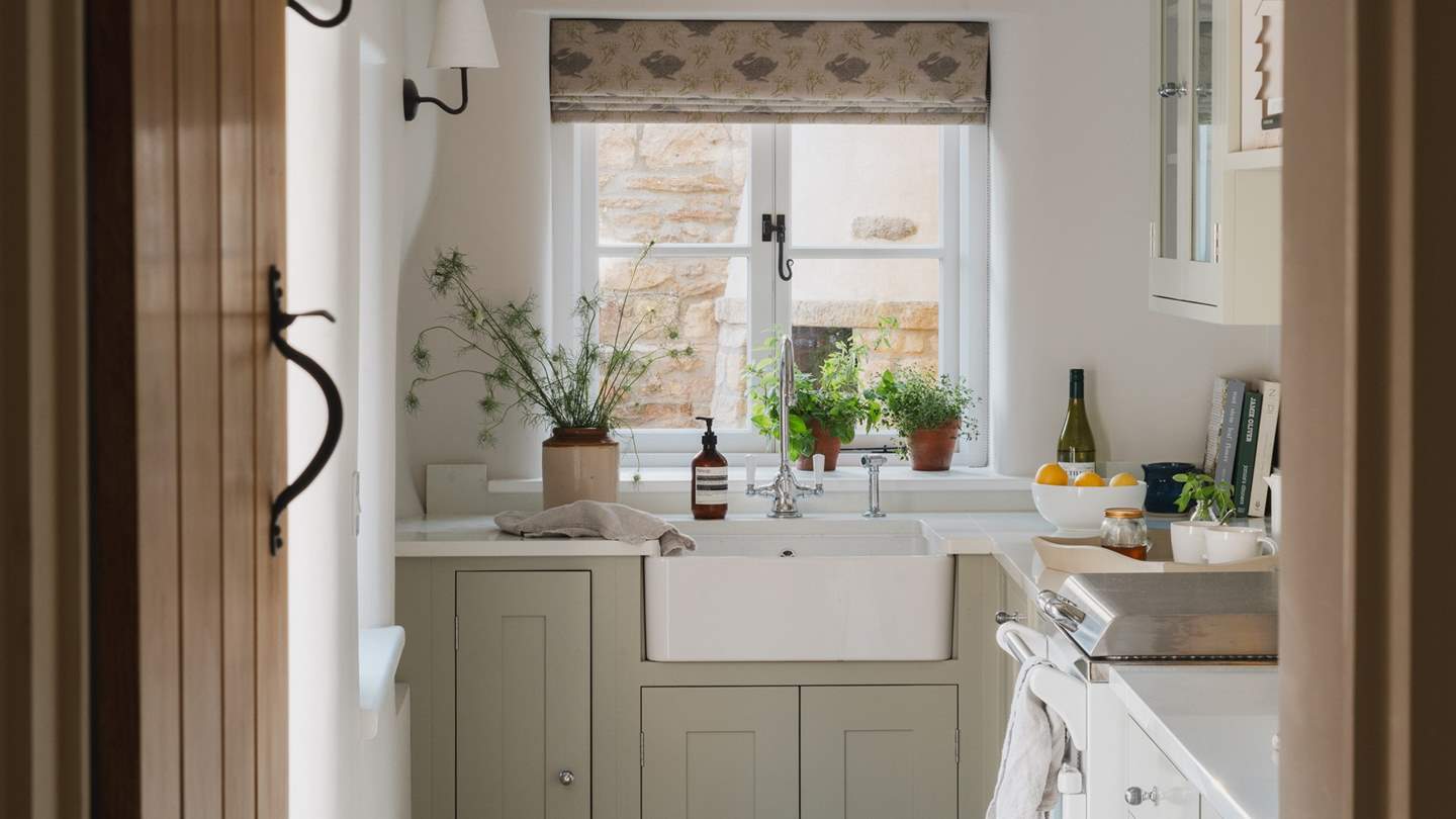 Within bespoke sage cabinetry, a range of accoutrements await