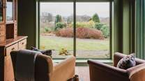 A stunning picture window looks out to the garden and beyond