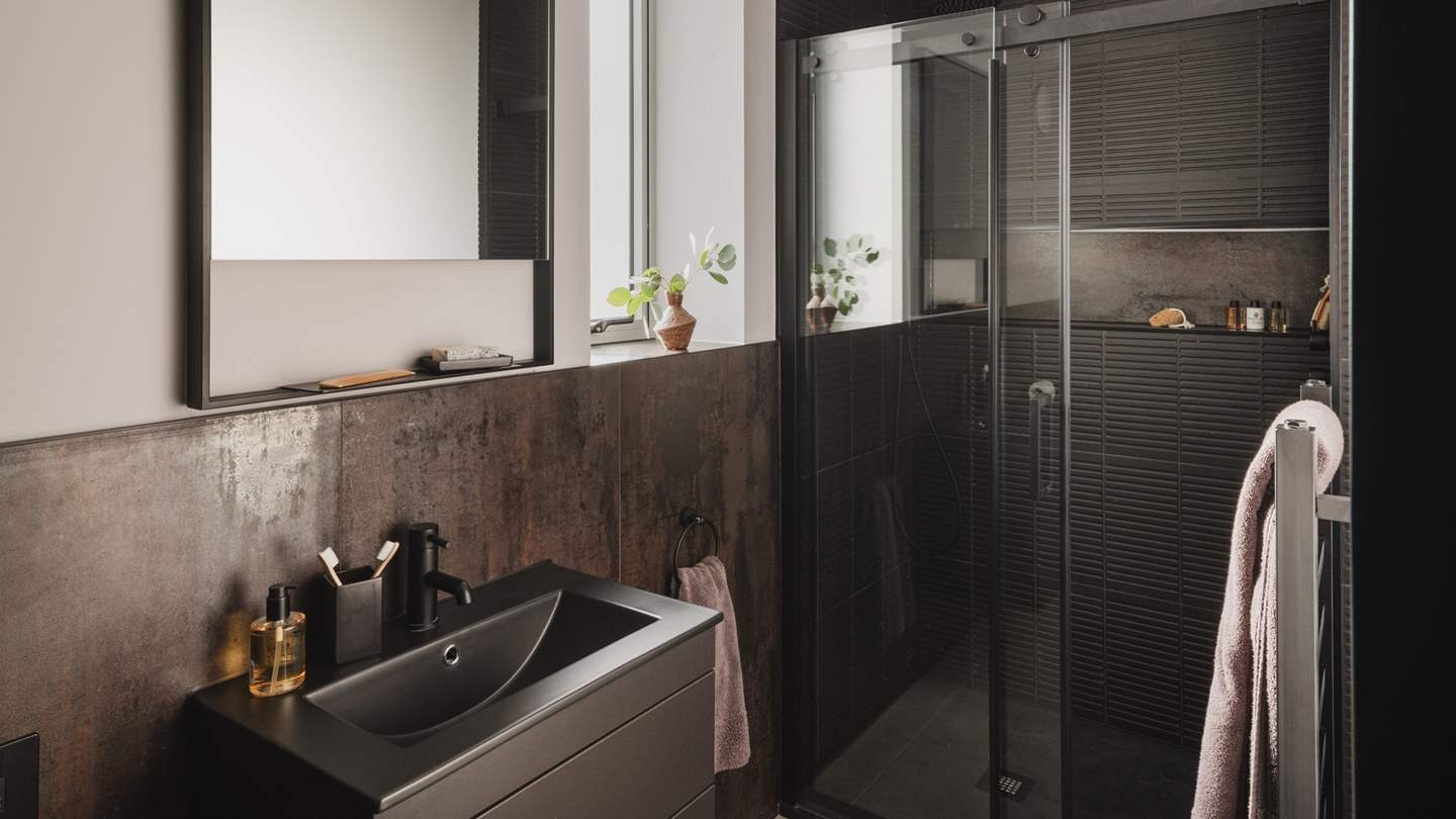 This bedroom benefits from a stylish ensuite bathroom with a walk-in shower