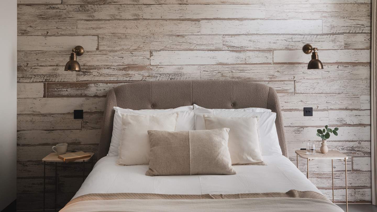 Step inside to uncover a tranquil oasis of quietude where wood panelling and soft hues create a soothing sanctuary for slumbers