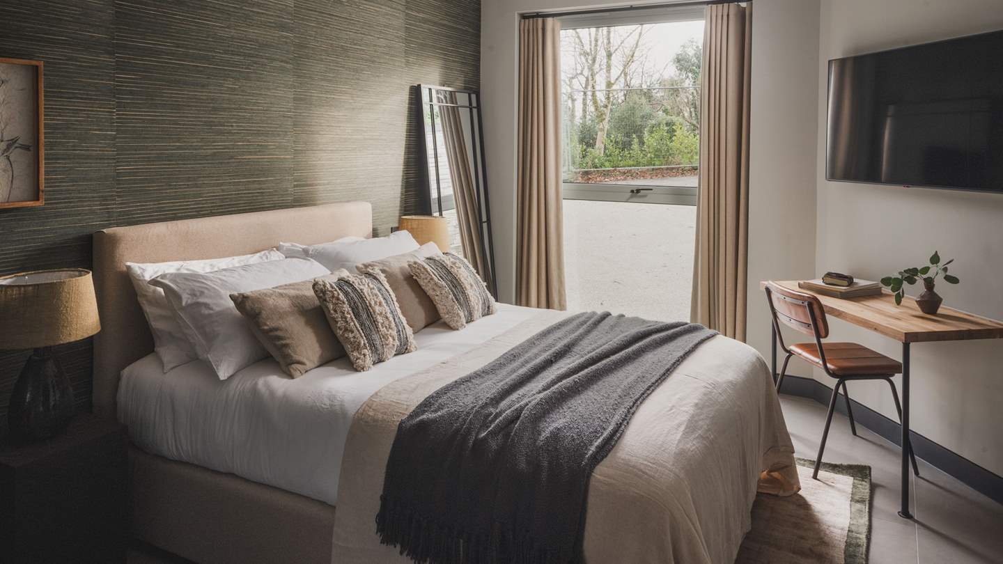 The fourth bedroom exudes calm and offers peaceful vistas across the garden