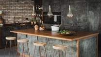 Pendant lights illuminate the setting, with reclaimed wood and handmade copper worktops offering plenty of space for keen chefs to craft culinary masterpieces