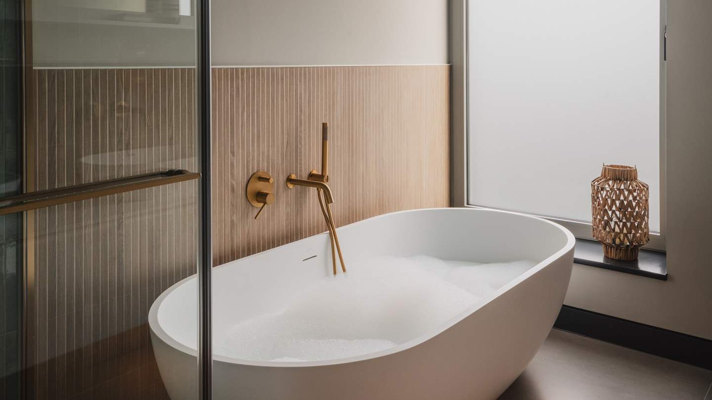 An additional bathroom can be found on the first floor between the kitchen and living room