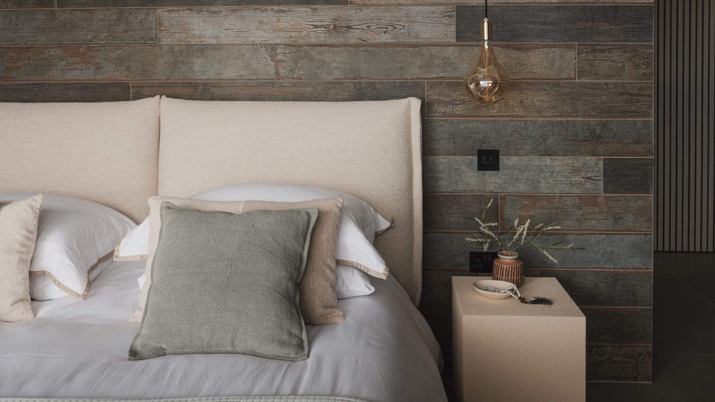 At the centre, a super king Roche Bobois bed sits pretty overlooking sliding glass doors and a sea-view balcony