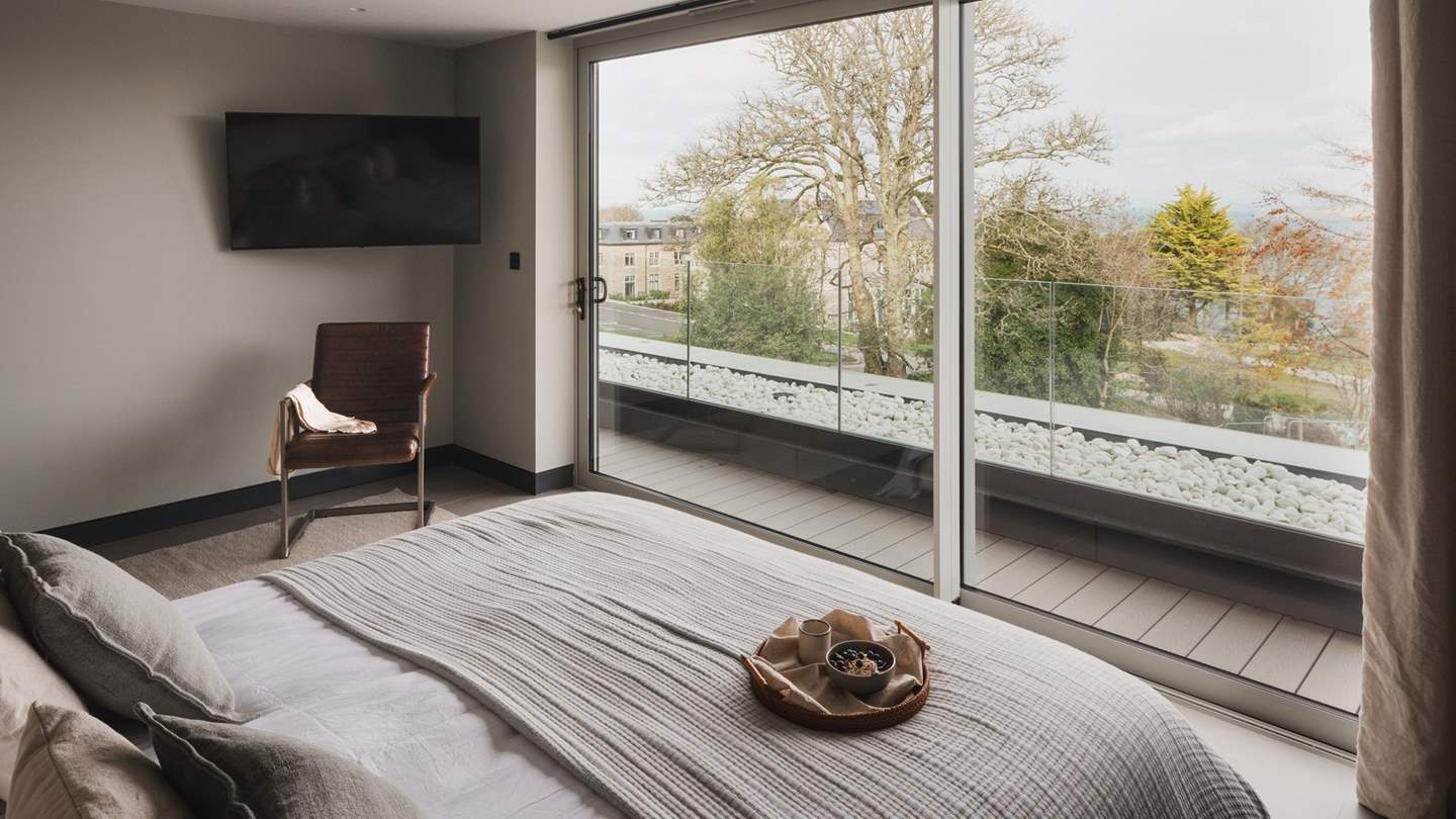The master bedroom resides on the second floor in a beautiful penthouse position above St Ives Bay
