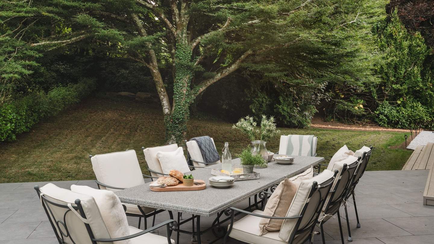 A dream for outdoor living, it features a plethora of bi-fold doors that open onto glass-fronted balconies, patios, and lawned gardens