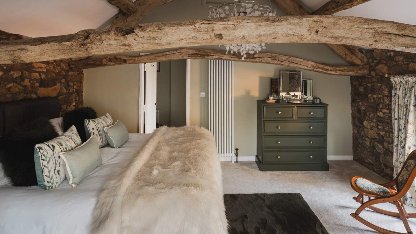 For storing belongings, uncover a chest of drawers in forest shades, topped with mirrors, with the addition of an antique wardrobe in soft sage hues