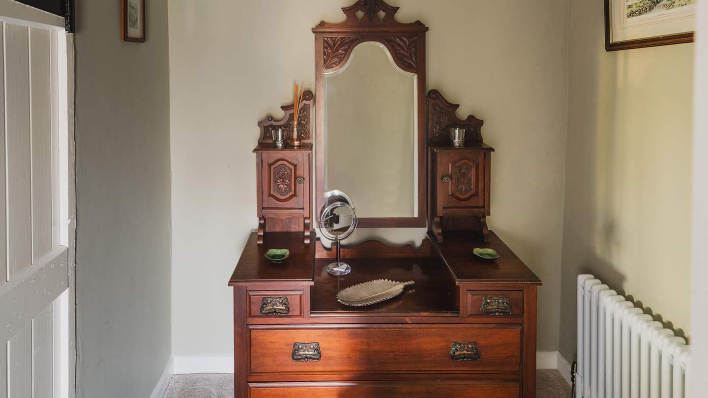 Relish self-care moments in the sweet dressing room, with a regal antique dressing table at its heart