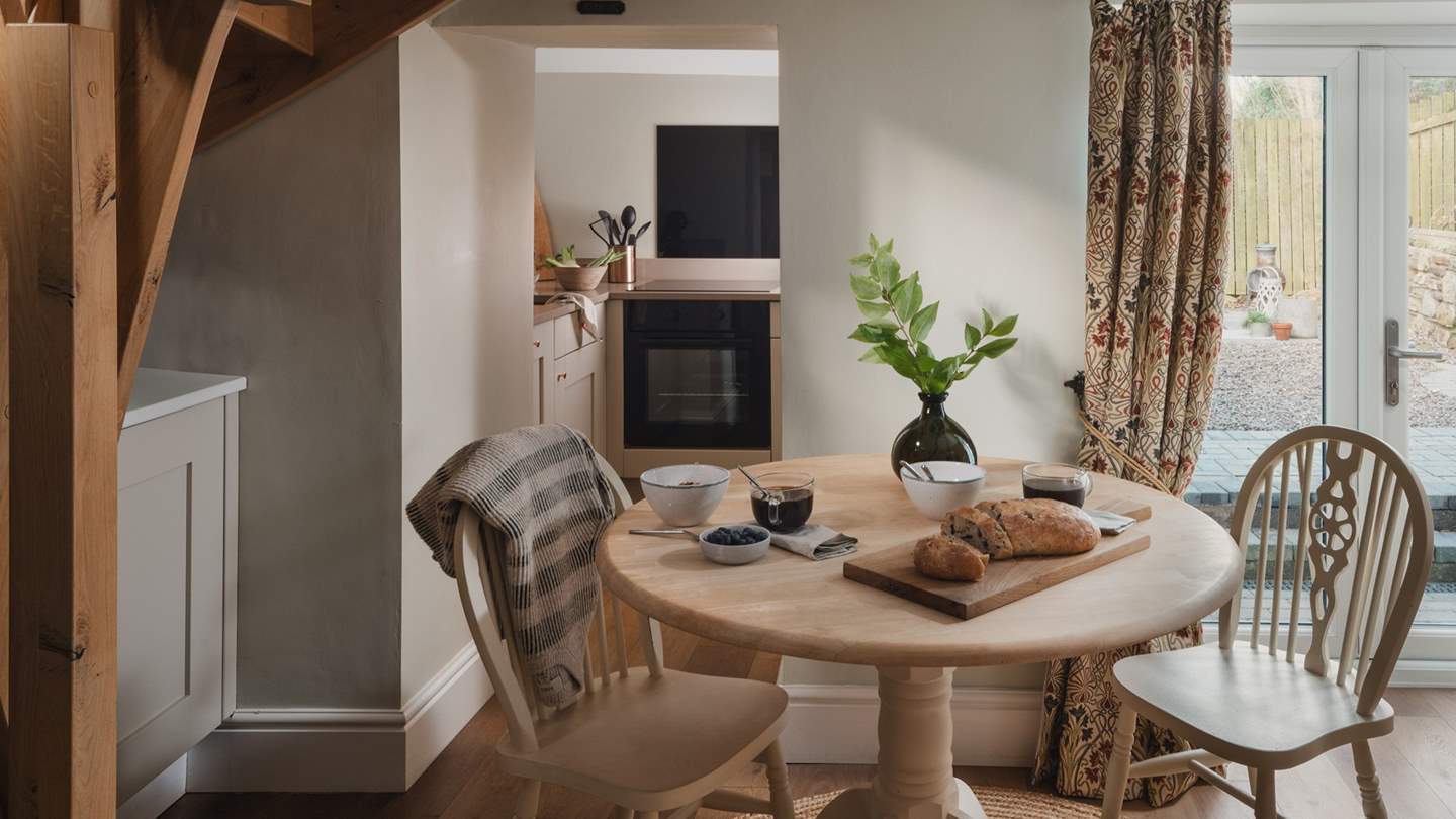At the far side of the living space, there’s an intimate dining table for two