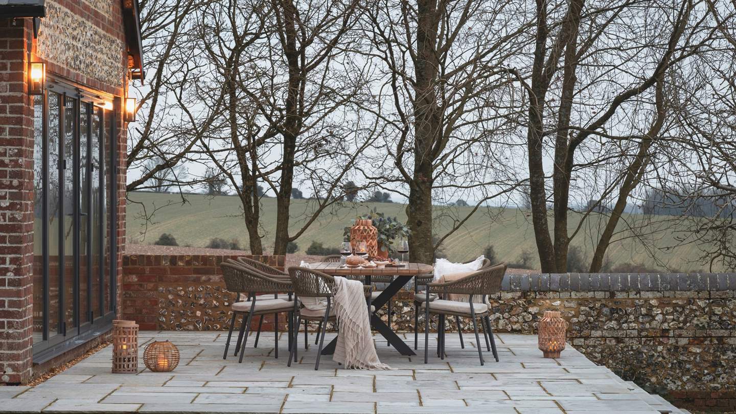 Extending from the additional lounge room, a tiered terrace is home to a spacious outdoor dining area for eight