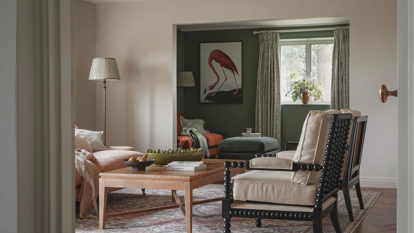 Adjoining the main living area is a darling snug in shades of forest green