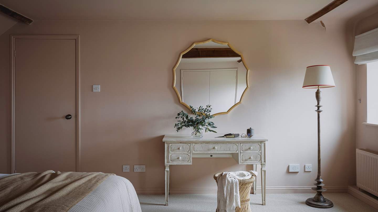 A windowside armchair proposes moments of quietude and a writing desk encourages creative reflection