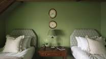 Exuding character, this divine space is bathed in green and ornamented by rustic beams radiating charm