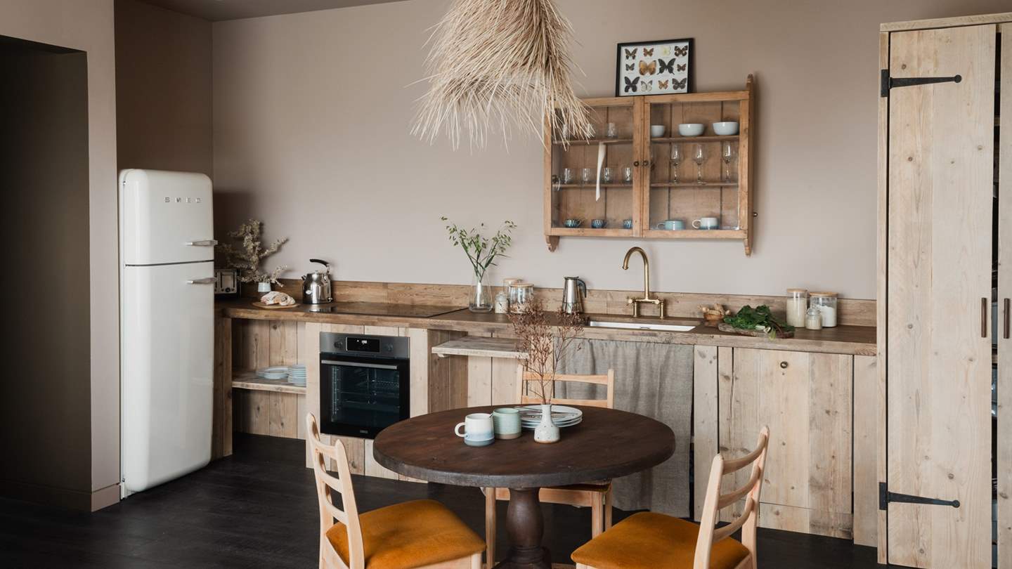 In the solid pine kitchen space you'll also find a walnut dining table for two