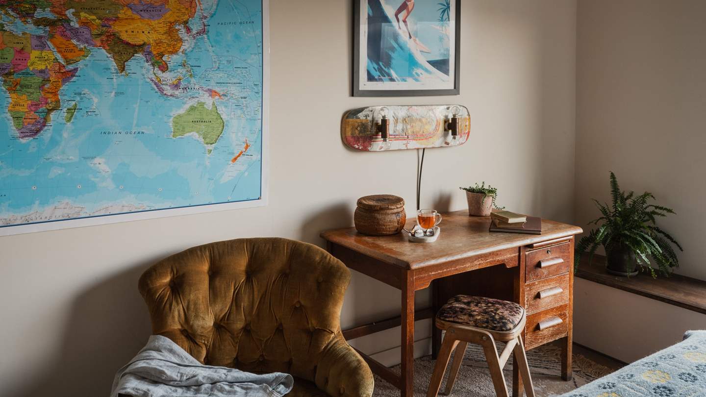 Along with a mustard velvet chesterfield chair, you'll find a wooden dressing table