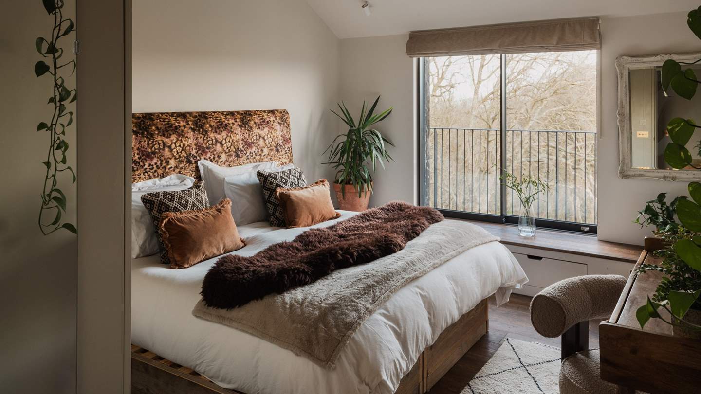 Nestled at the end of the corridor is the final bedroom, with a wall-mounted leopard print headboard and a 6ft zip and link bed