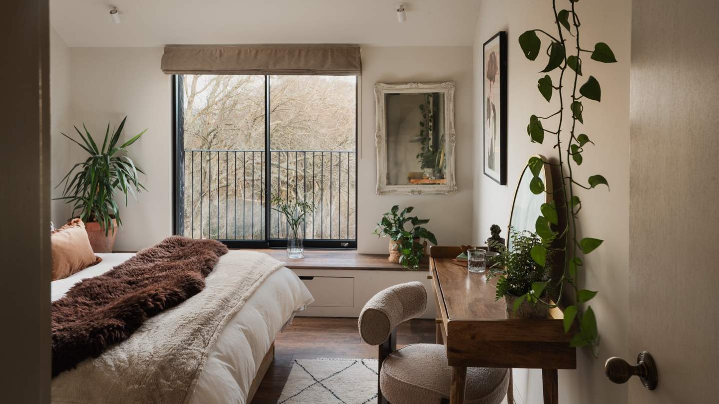 This space is beautifully softened with a mid-century aesthetic and greenery