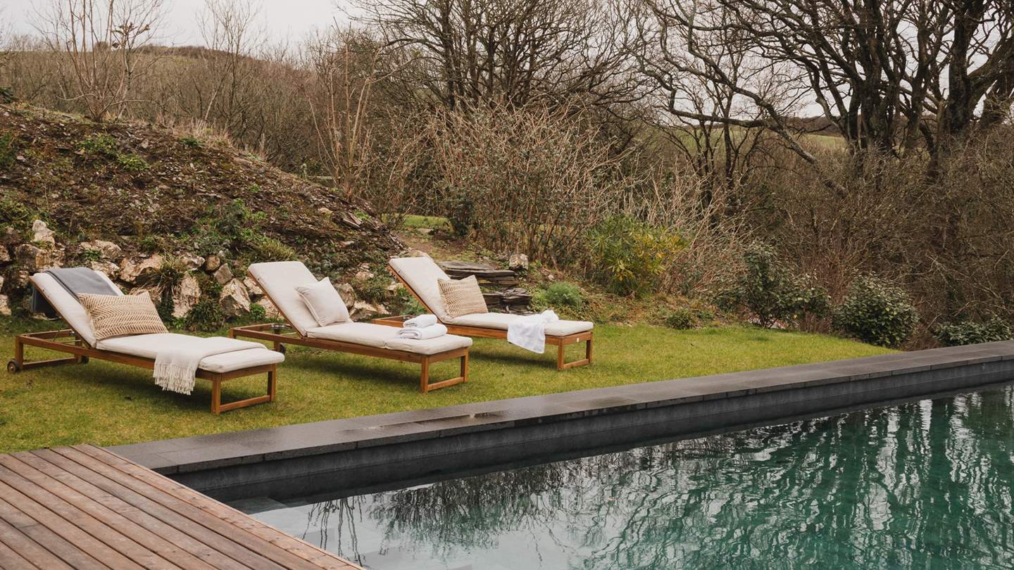 Unwinding poolside on the choice of luxe wooden loungers