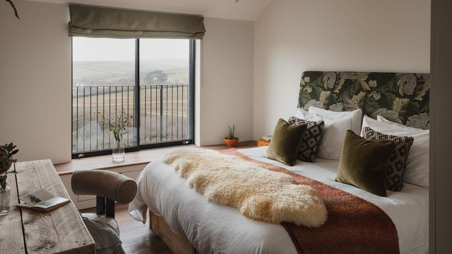 Lingering lie-ins await in the next bedroom, featuring a vaulted ceiling and a green botanical upholstered 6ft zip and link bed
