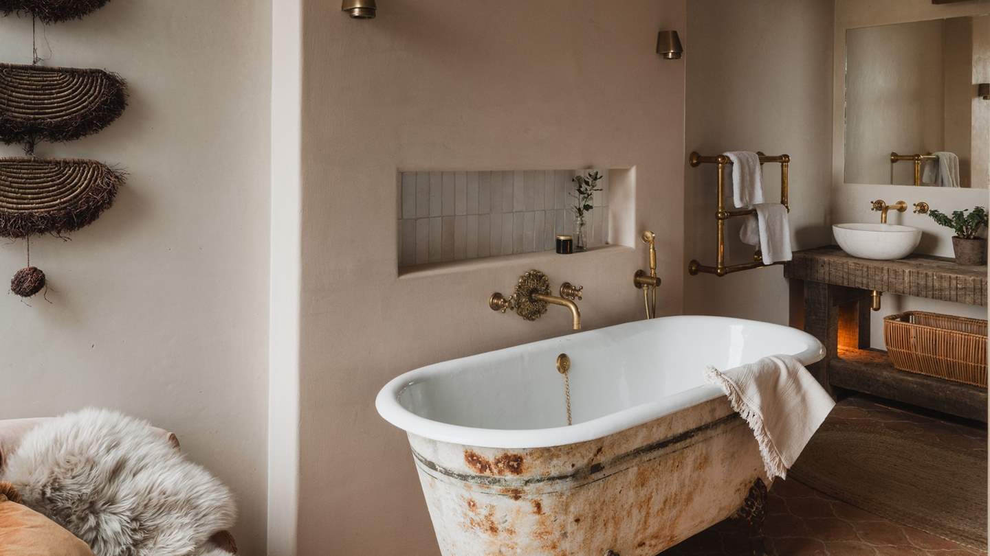 Embellished with reclaimed terracotta tiles, you'll find an antique claw foot bathtub and a large walk-in shower 