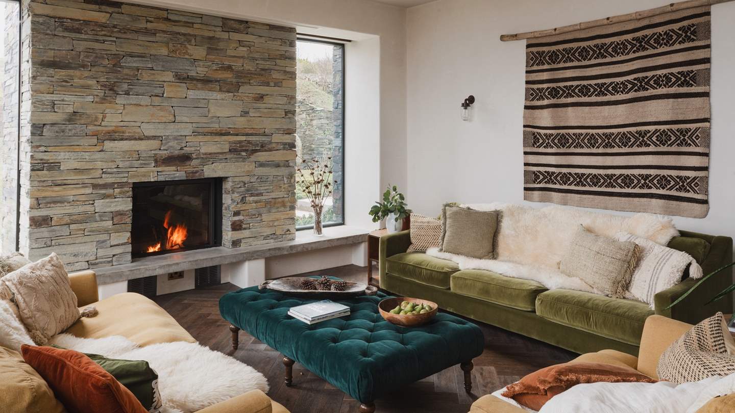 With an exposed stone chimney and a stunning open fire, this space is an aesthetic dream 