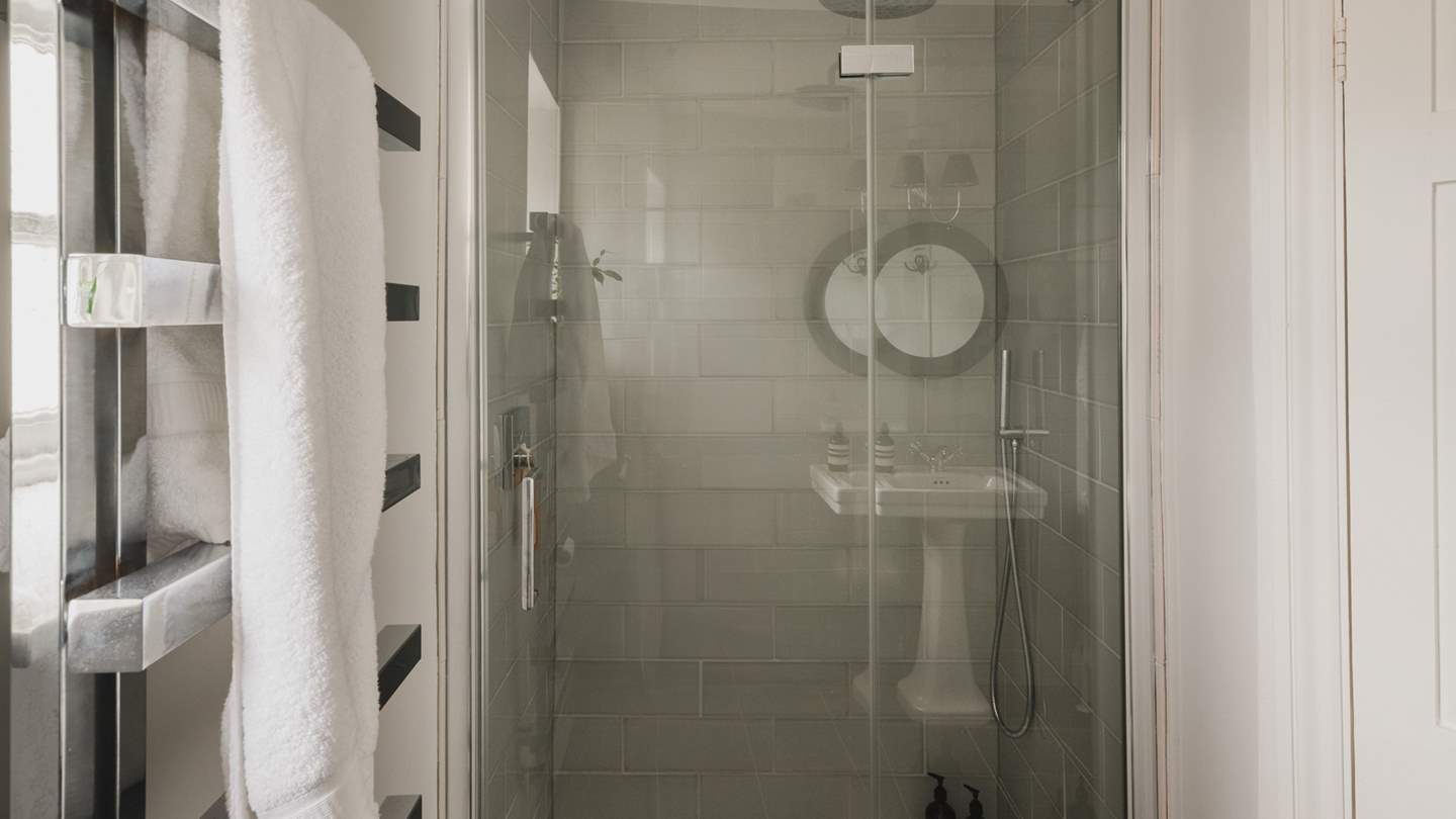 The family bathroom lies on the first floor, complete with a walk-in shower and heated towel rail