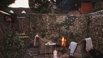 Cosy up beside the glow of the firepit...