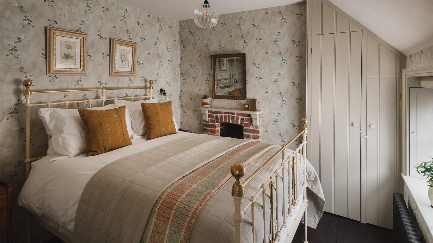 For those seeking extra space, the second bedroom in soft cream hues with mustard yellow inflections features an antique brass double bed