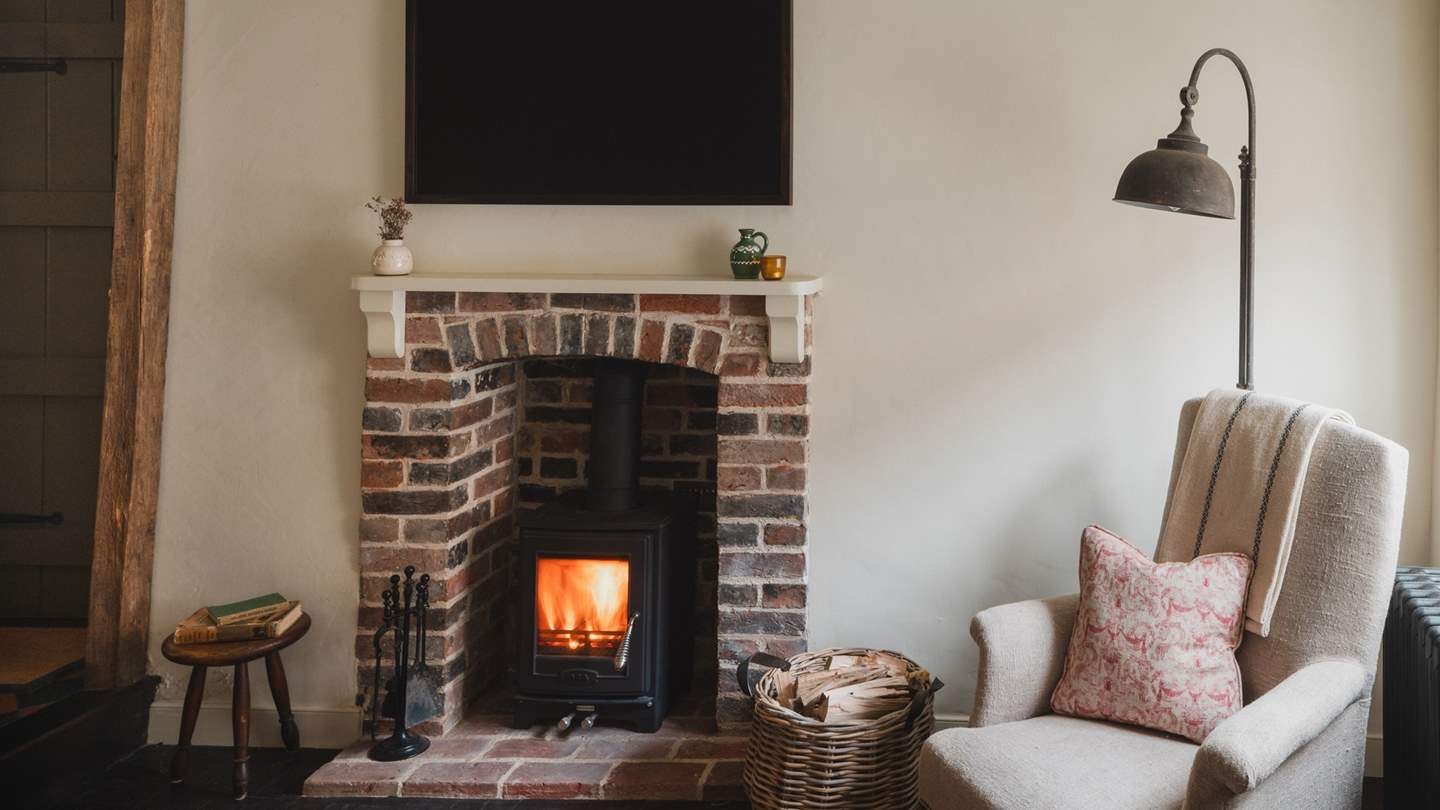 A  stunning brick fireplace offers evenings of fireside calm with a warming AGA wood burning stove