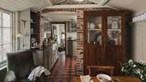 Savour moments of togetherness within the rustic, garden-view dining room with beautiful wood panelling and exposed stone walls