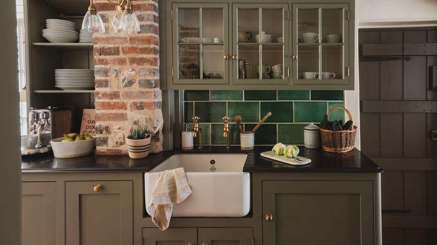 Complete with an AGA and Belfast sink, the space embodies a timeless country cottage feel with wood tones and exposed flintwork