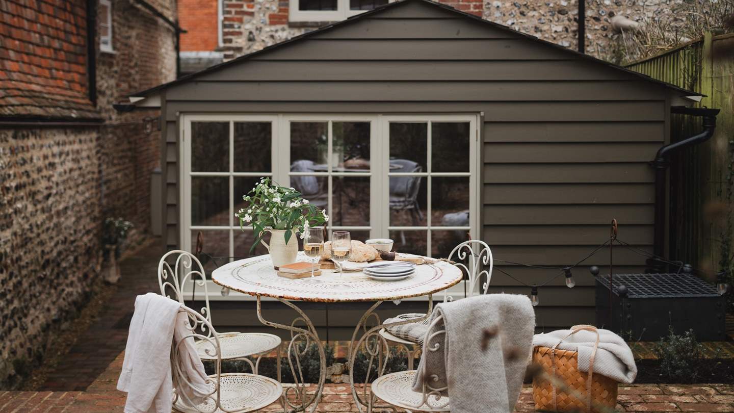 Gather for alfresco moments around the vintage iron bistro set