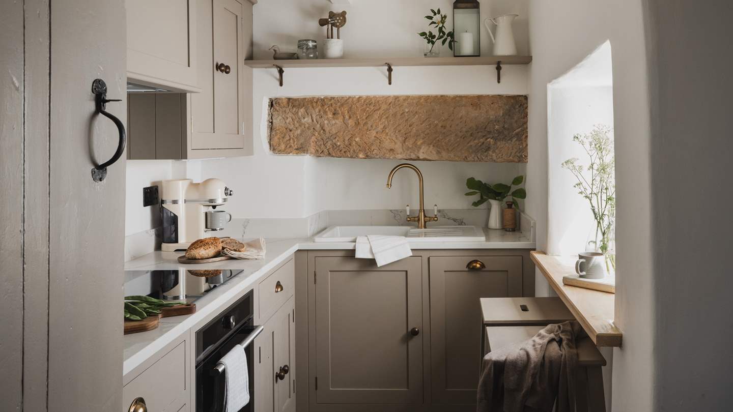 Cosy and characterful, the kitchen and dining space is designed in calming tones