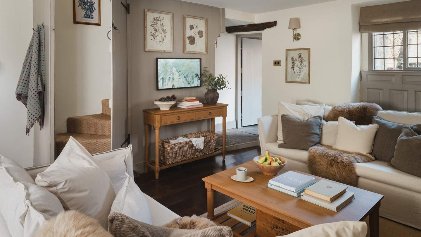 A small step leads into the inviting living space where curated corners and elegant interior features are endlessly romantic