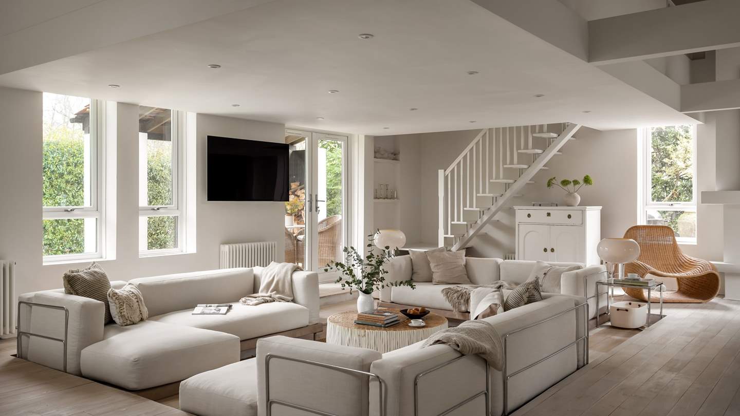Relish cosy moments in the sunken seating area, with three sumptuous sofas in oatmeal hues centred around a rustic coffee table