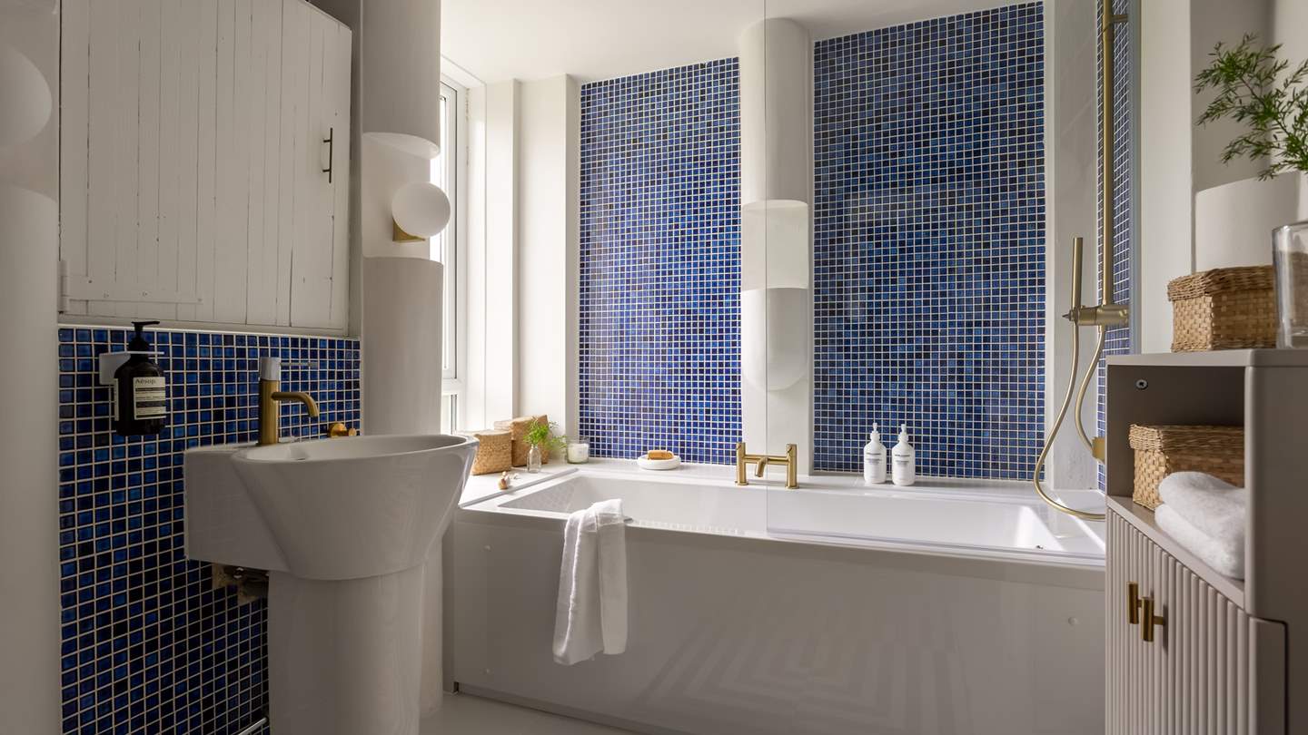 Step into the master ensuite, complete with a bathtub and overhead rainfall shower