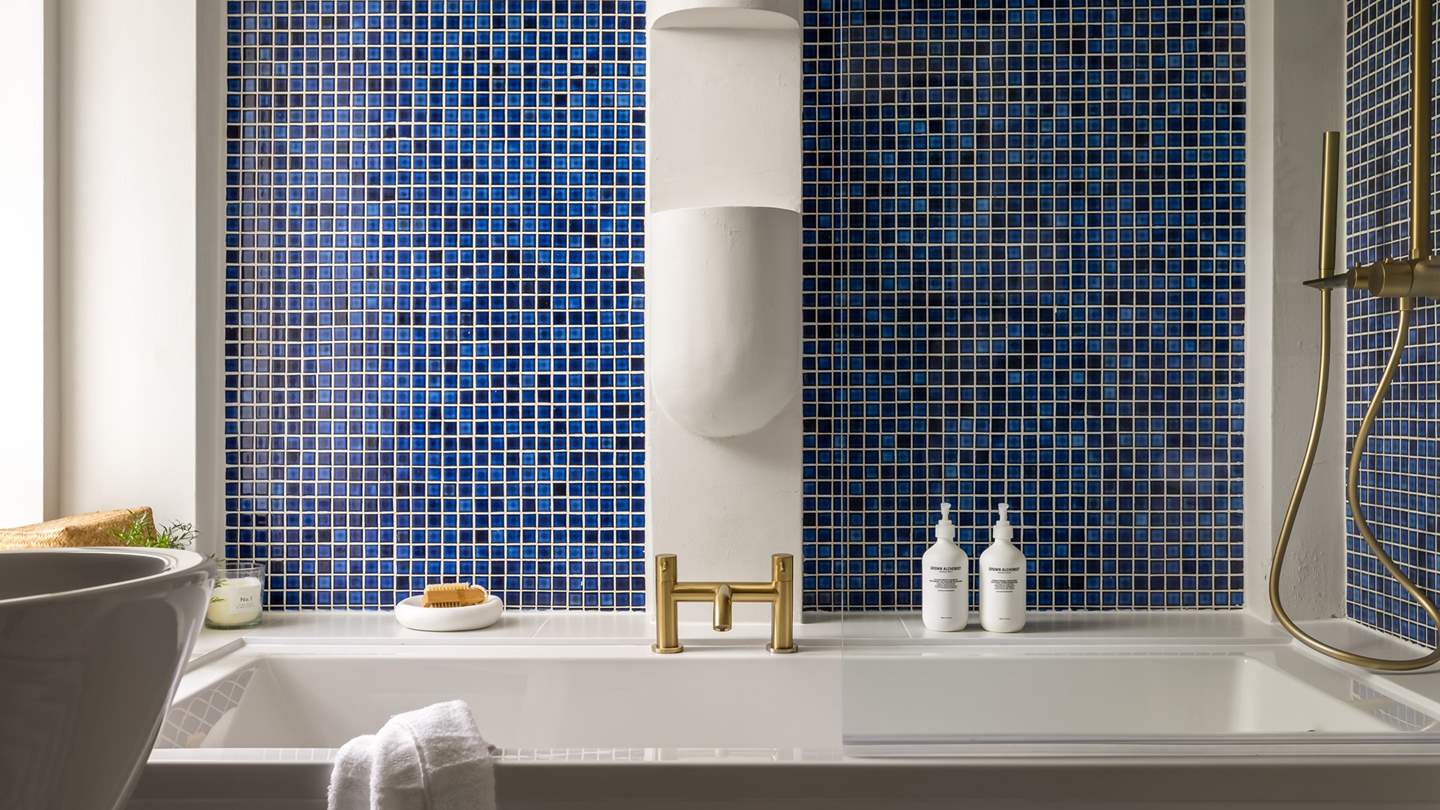Tiled in sumptuous shades of blue with exquisite brass detailing 