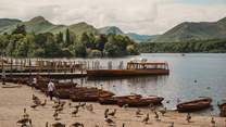 Hire a boat and sail around Derwentwater, exploring the secluded inlets and beaches