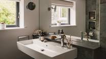 A dual sink is positioned before a large mirror - perfect for your morning self-care rituals 